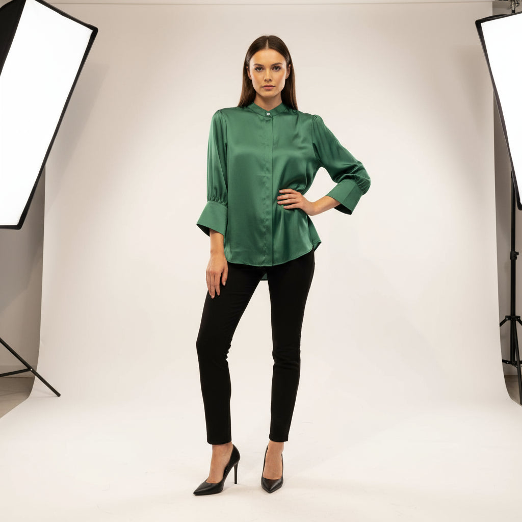 Green satin blouse on a british model against a beige background